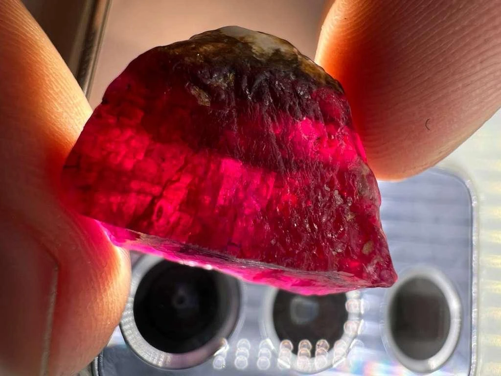 Ruby held to the light — client photograph